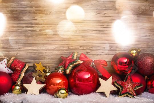 A festive arrangement of red and gold Christmas ornaments, stars, and decorations set on snowy ground against a wooden background, illuminated with soft, warm light and holiday sparkle.  : Stock Photo or Stock Video Download rcfotostock photos, images and assets rcfotostock | RC Photo Stock.: