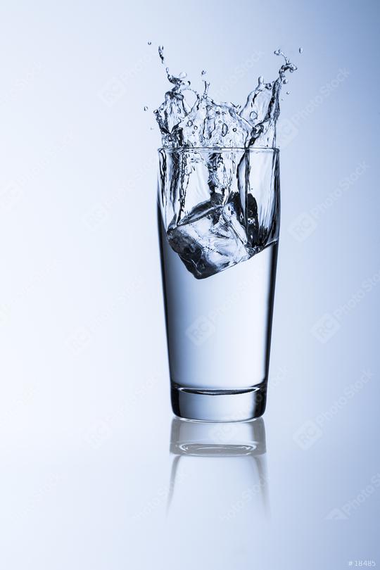 A glass of  drinking water with ice cube splash on blue willi cup background with reflection  : Stock Photo or Stock Video Download rcfotostock photos, images and assets rcfotostock | RC Photo Stock.: