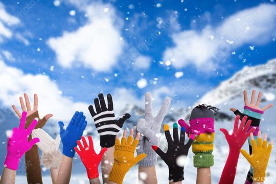 A group of colorful gloved hands raised into the snowy winter air, set against a bright blue sky and snowy mountain landscape, celebrating fun and joy in a festive outdoor winter scene.  : Stock Photo or Stock Video Download rcfotostock photos, images and assets rcfotostock | RC Photo Stock.:
