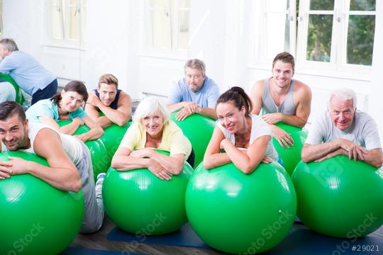 A group of diverse people of different ages enjoying an exercise class with green stability balls in a bright fitness studio, promoting health, teamwork, and an active lifestyle  : Stock Photo or Stock Video Download rcfotostock photos, images and assets rcfotostock | RC Photo Stock.: