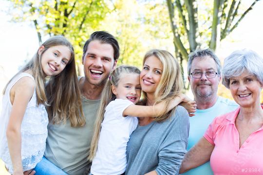 A happy multigenerational family smiling outdoors in a sunny park, including children, parents, and grandparents, enjoying quality time together
  : Stock Photo or Stock Video Download rcfotostock photos, images and assets rcfotostock | RC Photo Stock.: