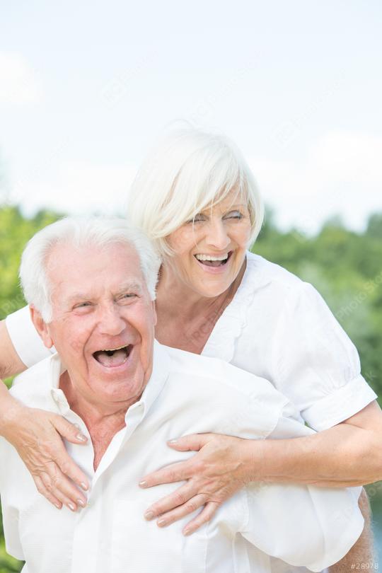 A happy senior couple laughing and enjoying an outdoor moment together, with a bright and joyful atmosphere and a green nature background on a sunny day.  : Stock Photo or Stock Video Download rcfotostock photos, images and assets rcfotostock | RC Photo Stock.: