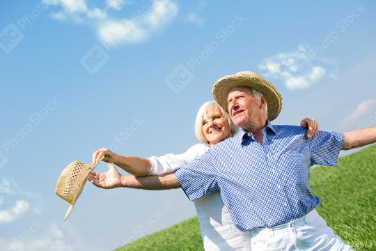A joyful senior couple embracing outdoors in a sunny field with clear blue skies, wearing straw hats, celebrating life, and enjoying their golden years together in nature  : Stock Photo or Stock Video Download rcfotostock photos, images and assets rcfotostock | RC Photo Stock.:
