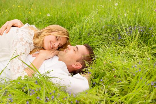 A loving couple lying on lush green grass surrounded by wildflowers, sharing a tender moment with bright smiles, symbolizing love and connection in a natural setting
  : Stock Photo or Stock Video Download rcfotostock photos, images and assets rcfotostock | RC Photo Stock.: