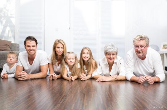 A multigenerational family lying together on the floor in a bright living room, smiling and showing unity, featuring grandparents, parents, and children in casual white outfits  : Stock Photo or Stock Video Download rcfotostock photos, images and assets rcfotostock | RC Photo Stock.: