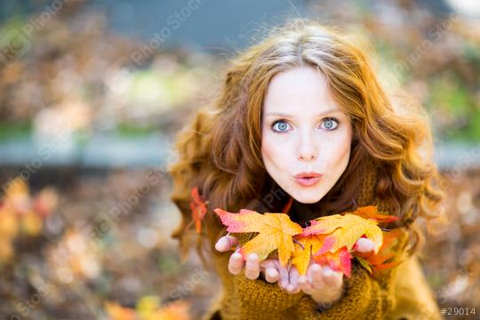 A red-haired woman in an autumn setting, holding colorful fall leaves in her hands, blowing them playfully, surrounded by warm tones and a blurred natural background
  : Stock Photo or Stock Video Download rcfotostock photos, images and assets rcfotostock | RC Photo Stock.: