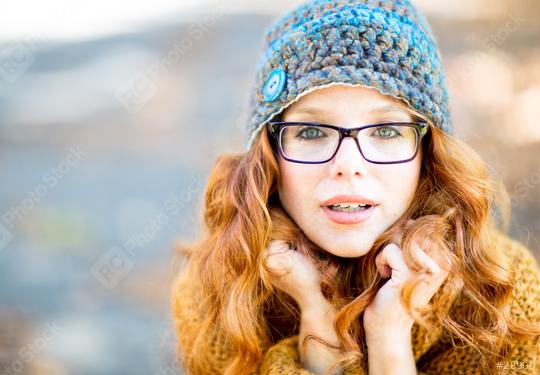 A red-haired woman with glasses and a knitted hat, looking at the camera with a curious and warm expression, wearing a cozy sweater, outdoors in a soft autumn light
  : Stock Photo or Stock Video Download rcfotostock photos, images and assets rcfotostock | RC Photo Stock.: