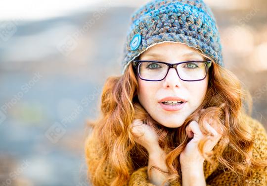 A red-haired woman with glasses and a knitted hat, looking at the camera with a curious and warm expression, wearing a cozy sweater, outdoors in a soft autumn light  : Stock Photo or Stock Video Download rcfotostock photos, images and assets rcfotostock | RC Photo Stock.: