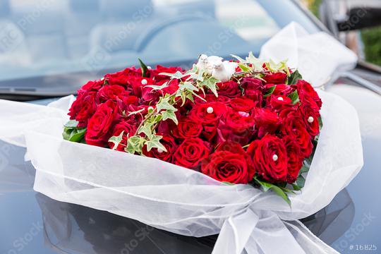 A stylish decoration of red rose flowers, ribbons on a shiny black wedding car  : Stock Photo or Stock Video Download rcfotostock photos, images and assets rcfotostock | RC-Photo-Stock.: