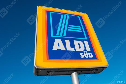 AAACHEN, GERMANY JANUARY, 2017: Aldi Süd logo against blue sky in germany  The German-based discount supermarket chain currently operates over 10,000 stores.  : Stock Photo or Stock Video Download rcfotostock photos, images and assets rcfotostock | RC Photo Stock.: