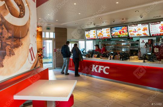 AACHEN, GERMANY FEBRUARY, 2017: People Order Kentucky Fried Chicken In Fast-Food Restaurant. It is a fast food restaurant chain headquartered in United States specialized in chicken products.  : Stock Photo or Stock Video Download rcfotostock photos, images and assets rcfotostock | RC Photo Stock.: