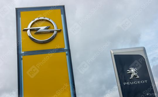 AACHEN, GERMANY FEBRUARY, 2017: Peugeot and Opel dealership sign against cloudy sky. Peugeot is a French automobile manufacturer and part of Groupe PSA. Opel AG is a German automobile manufacturer.  : Stock Photo or Stock Video Download rcfotostock photos, images and assets rcfotostock | RC Photo Stock.: