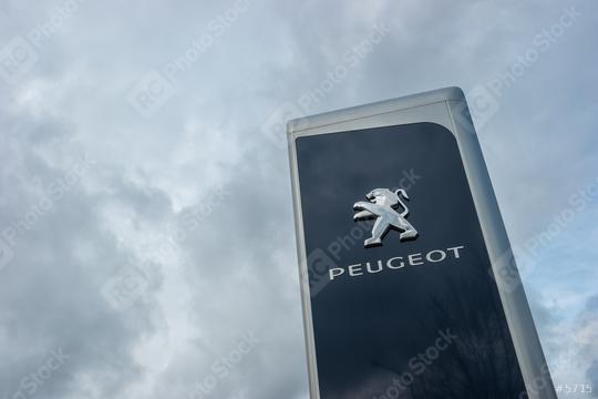 AACHEN, GERMANY FEBRUARY, 2017: Peugeot dealership sign against cloudy sky. Peugeot is a French automobile manufacturer and part of Groupe PSA.  : Stock Photo or Stock Video Download rcfotostock photos, images and assets rcfotostock | RC Photo Stock.: