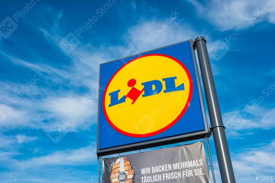 AACHEN, GERMANY JANUARY, 2017: LIDL supermarket chain sign against the blue cloudy sky. LIDL is a German global discount supermarket chain, based in Neckarsulm, Baden-Wuerttemberg, Germany.  : Stock Photo or Stock Video Download rcfotostock photos, images and assets rcfotostock | RC Photo Stock.: