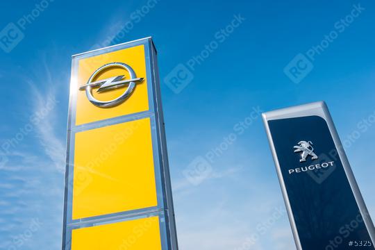 AACHEN, GERMANY MARCH, 2017: Peugeot and Opel dealership sign against blue sky. Peugeot is a French automobile manufacturer and part of Groupe PSA. Opel AG is a German automobile manufacturer.  : Stock Photo or Stock Video Download rcfotostock photos, images and assets rcfotostock | RC Photo Stock.: