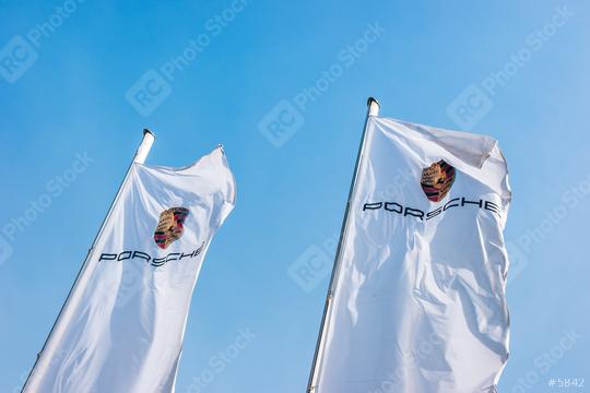 AACHEN, GERMANY MARCH, 2017: Porsche Sign on a flags against blue sky. Ferdinand Porsche founded the company in 1931 with main offices in the centre of Stuttgart.  : Stock Photo or Stock Video Download rcfotostock photos, images and assets rcfotostock | RC Photo Stock.: