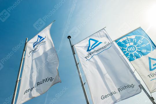 AACHEN, GERMANY MARCH, 2017: The Logo of the "TÜV Rheinland Deutschland" on a flags. The TÜV Rheinland AG is an internationally active, independent test service provider based in Cologne.  : Stock Photo or Stock Video Download rcfotostock photos, images and assets rcfotostock | RC Photo Stock.: