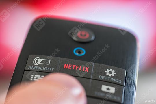 AACHEN, GERMANY OCTOBER, 2017:Man holds a remote control with a Netflix button. Netflix Inc. is an American company founded specializes in and provides streaming media and video on demand online.  : Stock Photo or Stock Video Download rcfotostock photos, images and assets rcfotostock | RC Photo Stock.: