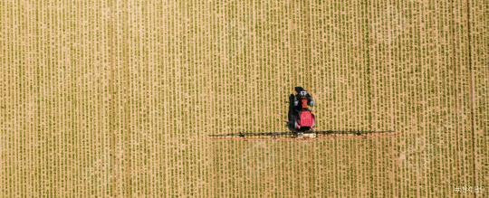 Aerial image of tractor spraying soil and young crop in springtime in field  : Stock Photo or Stock Video Download rcfotostock photos, images and assets rcfotostock | RC Photo Stock.: