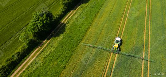 Aerial view of a tractor spraying the field. Chemistry in agriculture from drone view. Modern farming background concept.  : Stock Photo or Stock Video Download rcfotostock photos, images and assets rcfotostock | RC Photo Stock.: