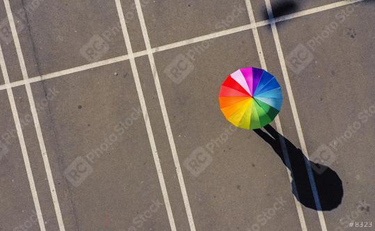 Aerial view of woman holding rainbow umbrella parking lot background - view from a drone  : Stock Photo or Stock Video Download rcfotostock photos, images and assets rcfotostock | RC Photo Stock.: