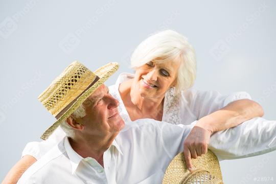 An affectionate senior couple smiling at each other, wearing white outfits and straw hats, enjoying a serene moment together, symbolizing love, companionship, and happiness in their golden years
  : Stock Photo or Stock Video Download rcfotostock photos, images and assets rcfotostock | RC Photo Stock.: