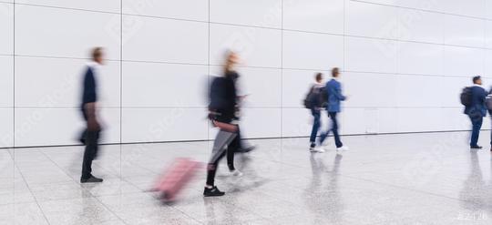 Anonymous blurred crowd of business people walks by gear on a trade fair or in an airport  : Stock Photo or Stock Video Download rcfotostock photos, images and assets rcfotostock | RC Photo Stock.: