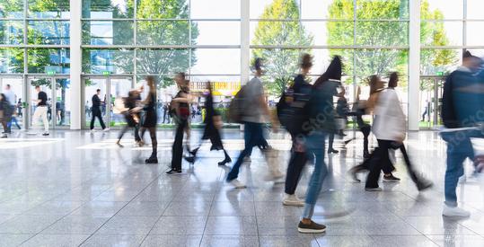 Anonymous blurred crowd of business people walks by gear on a trade fair or in an airport  : Stock Photo or Stock Video Download rcfotostock photos, images and assets rcfotostock | RC Photo Stock.: