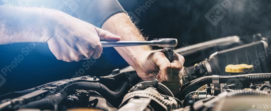 Auto mechanic working on car engine in mechanics garage. Repair service. authentic close-up shot, banner size  : Stock Photo or Stock Video Download rcfotostock photos, images and assets rcfotostock | RC-Photo-Stock.: