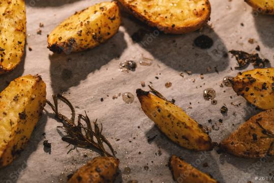 Baked potato wedges with rosemary and oil in a oven -  homemade organic vegetable vegan vegetarian potato wedges snack food meal.  : Stock Photo or Stock Video Download rcfotostock photos, images and assets rcfotostock | RC Photo Stock.: