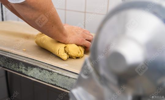 baker kneading a block of cookie dough on a countertop in a bakery, preparing it for further processing, with a rolling machine visible in the background  : Stock Photo or Stock Video Download rcfotostock photos, images and assets rcfotostock | RC Photo Stock.:
