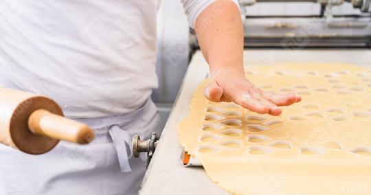 baker prepares cookie dough, cutting out heart shapes with a rolling pin nearby. The dough is arranged on a flat surface, showcasing the precision of the baking process  : Stock Photo or Stock Video Download rcfotostock photos, images and assets rcfotostock | RC Photo Stock.: