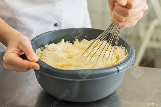 baker woman holding bowl with dough and whisk to beat stirring butter for a cake   : Stock Photo or Stock Video Download rcfotostock photos, images and assets rcfotostock | RC Photo Stock.:
