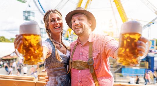 Bavarian couple in traditional Bavarian attire cheerfully toasting with beer mugs at oktoberfest or duld in germany  : Stock Photo or Stock Video Download rcfotostock photos, images and assets rcfotostock | RC Photo Stock.: