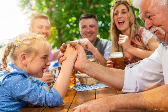 Bavarian family practicing the high art of arm wrestling in a beer garden  : Stock Photo or Stock Video Download rcfotostock photos, images and assets rcfotostock | RC Photo Stock.: