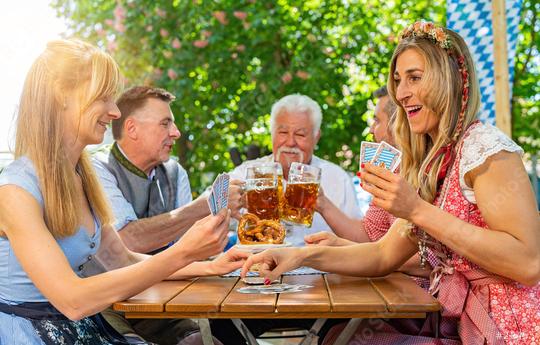 Bavarian people in traditional costume playing cards in beer garden or oktoberfest  : Stock Photo or Stock Video Download rcfotostock photos, images and assets rcfotostock | RC Photo Stock.: