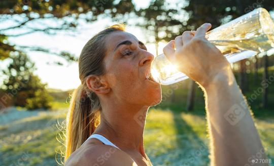 Beautiful girl in sportswear drinks water from a bottle at morning on the beach  : Stock Photo or Stock Video Download rcfotostock photos, images and assets rcfotostock | RC Photo Stock.: