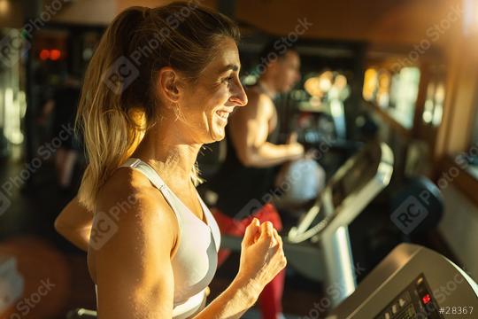 Beautiful woman exercising on treadmill in gym  : Stock Photo or Stock Video Download rcfotostock photos, images and assets rcfotostock | RC Photo Stock.: