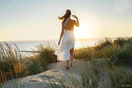 beautiful woman walks barefoot through sand dunes towards to sea at sunset  : Stock Photo or Stock Video Download rcfotostock photos, images and assets rcfotostock | RC Photo Stock.: