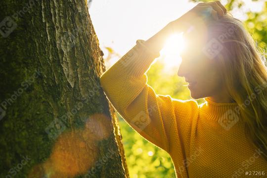 beautiful woman with long blond hair leans against a tree on a sunny day in the Nature  : Stock Photo or Stock Video Download rcfotostock photos, images and assets rcfotostock | RC Photo Stock.: