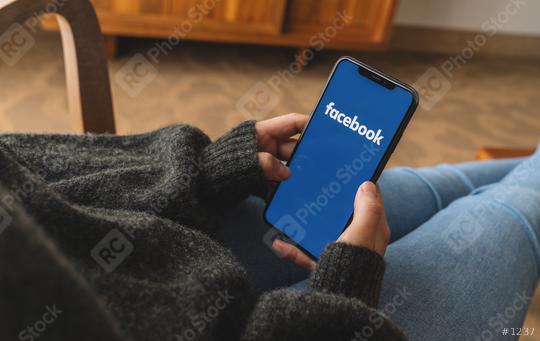 BERLIN, GERMANY AUGUST 2019:  Woman hand holding iphone Xs with logo of Facebook application in a living roo. Facebook is an online social networking service founded in February 2004 by Mark Zuckerber  : Stock Photo or Stock Video Download rcfotostock photos, images and assets rcfotostock | RC Photo Stock.: