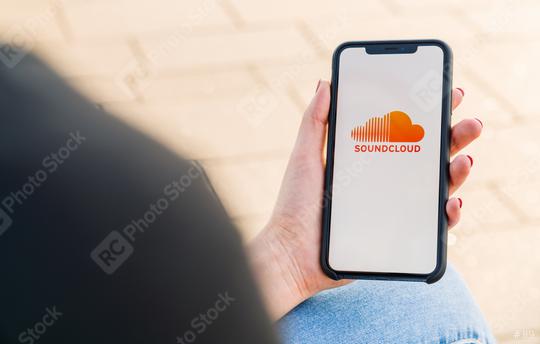 BERLIN, GERMANY AUGUST 2019: Woman hand holding iphone Xs opening soundcloud Music streaming app in the city. Streaming music via the Internet   : Stock Photo or Stock Video Download rcfotostock photos, images and assets rcfotostock | RC Photo Stock.: