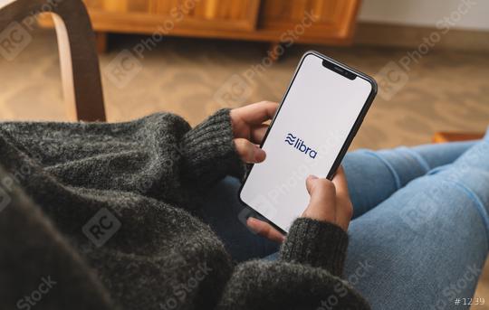 BERLIN, GERMANY AUGUST 2019: Woman hand holding iphone Xs with logo of Libra in a living room. Libra Facebook cryptocurrency and bitcoin cryptocurrency smartphone share, Libra coins concept.  : Stock Photo or Stock Video Download rcfotostock photos, images and assets rcfotostock | RC Photo Stock.: