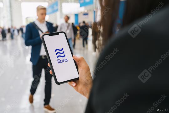 BERLIN, GERMANY AUGUST 2019: Woman hand holding iphone Xs with logo of Libra at a conference. Libra Facebook cryptocurrency and bitcoin cryptocurrency smartphone share, Libra coins concept.  : Stock Photo or Stock Video Download rcfotostock photos, images and assets rcfotostock | RC Photo Stock.: