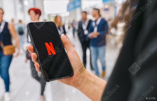BERLIN, GERMANY AUGUST 2019: Woman hand holding iphone Xs with logo of Netflix app. Young woman is browsing the movie video library what to watch.  : Stock Photo or Stock Video Download rcfotostock photos, images and assets rcfotostock | RC Photo Stock.: