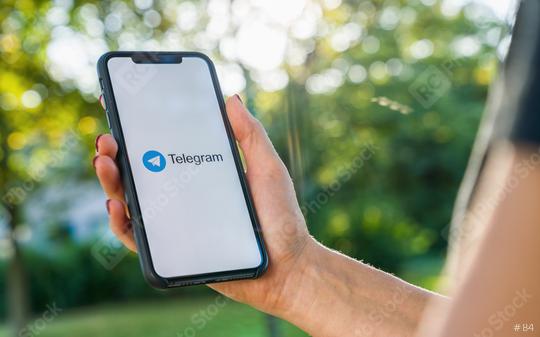 BERLIN, GERMANY AUGUST 2019: Woman hand holding iphone Xs with logo of Telegram application. Telegram app icon. Telegram is an online social media network. Social media app  : Stock Photo or Stock Video Download rcfotostock photos, images and assets rcfotostock | RC Photo Stock.: