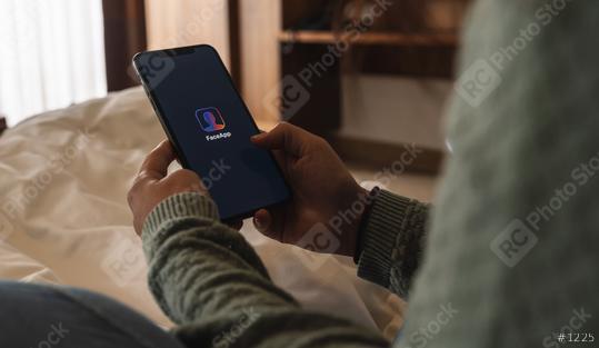 BERLIN, GERMANY AUGUST 2019: Woman holding a iPhone Xs opening Face app at bed, faceapp is a popular photo editing application on the App Store.  : Stock Photo or Stock Video Download rcfotostock photos, images and assets rcfotostock | RC Photo Stock.: