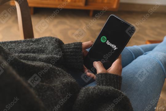 BERLIN, GERMANY AUGUST 2019: Woman holding a iPhone Xs opening spotify app, Spotify is a music service that offers legal streaming music.  : Stock Photo or Stock Video Download rcfotostock photos, images and assets rcfotostock | RC Photo Stock.: