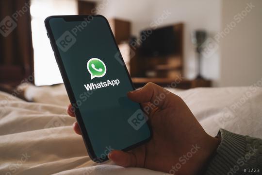 BERLIN, GERMANY AUGUST 2019: Woman holding a iPhone Xs opening Whatsapp app in a hotel room. WhatsApp messenger for sending messages via the Internet.  : Stock Photo or Stock Video Download rcfotostock photos, images and assets rcfotostock | RC Photo Stock.:
