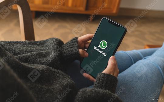 BERLIN, GERMANY AUGUST 2019: Woman holding a iPhone Xs opening Whatsapp app in a living room. WhatsApp messenger for sending messages via the Internet.  : Stock Photo or Stock Video Download rcfotostock photos, images and assets rcfotostock | RC Photo Stock.:
